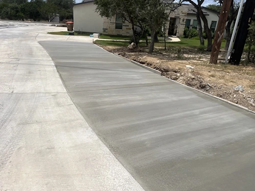 Freshly poured concrete driveway expansion
