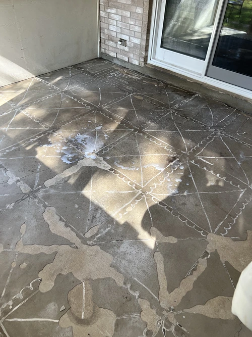 Worn patio slab being prepped for a concrete overlay